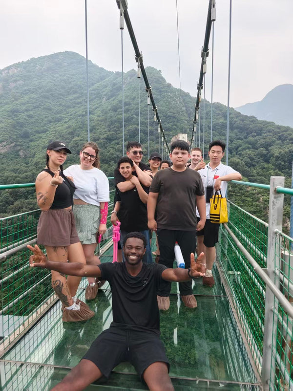 Students on the glass suspension bridge over Mount Song near the Songshan Shaolin Temple scenic area
