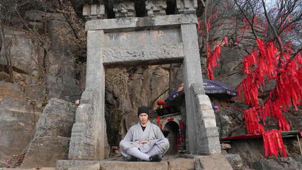A Shaolin monk meditating outside the Damo Cave on Songshan, where Bodhidharma is said to have sat for nine years